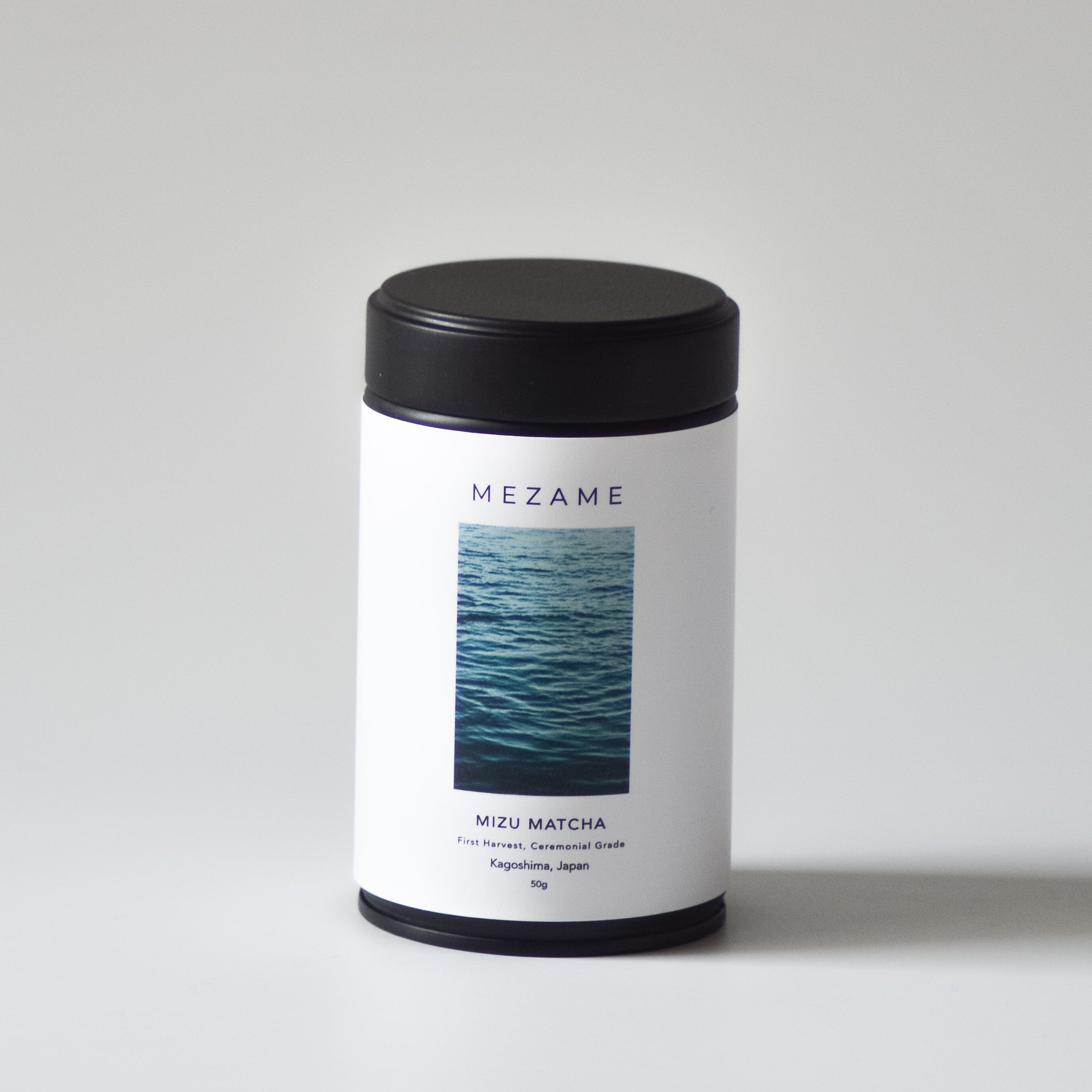 Matcha tea tin with a label featuring an ocean design on a white background