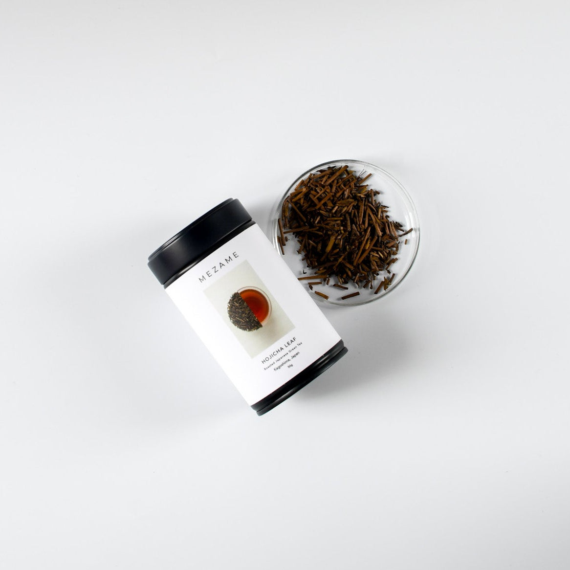 Tea packaging with loose Japanese hojicha tea on a white background