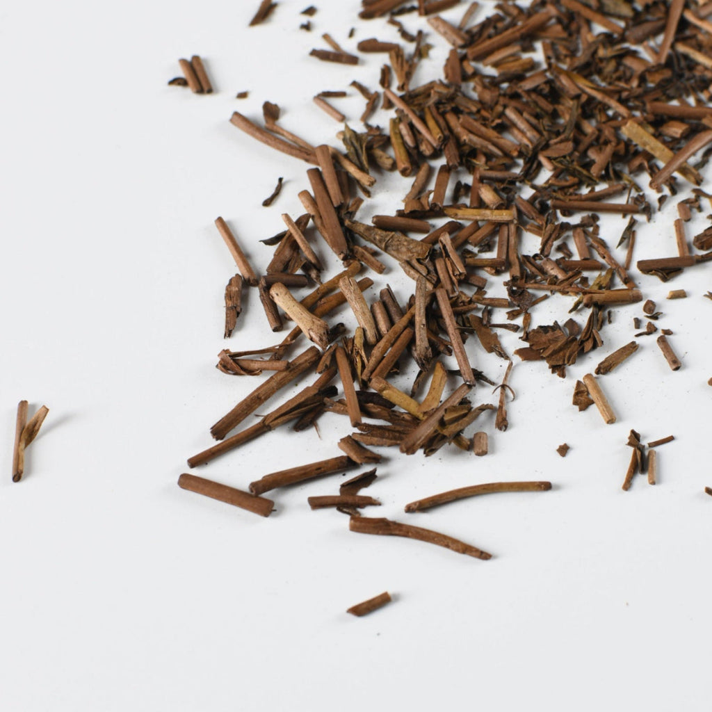 Japanese hojicha roasted green tea leaves on a white background