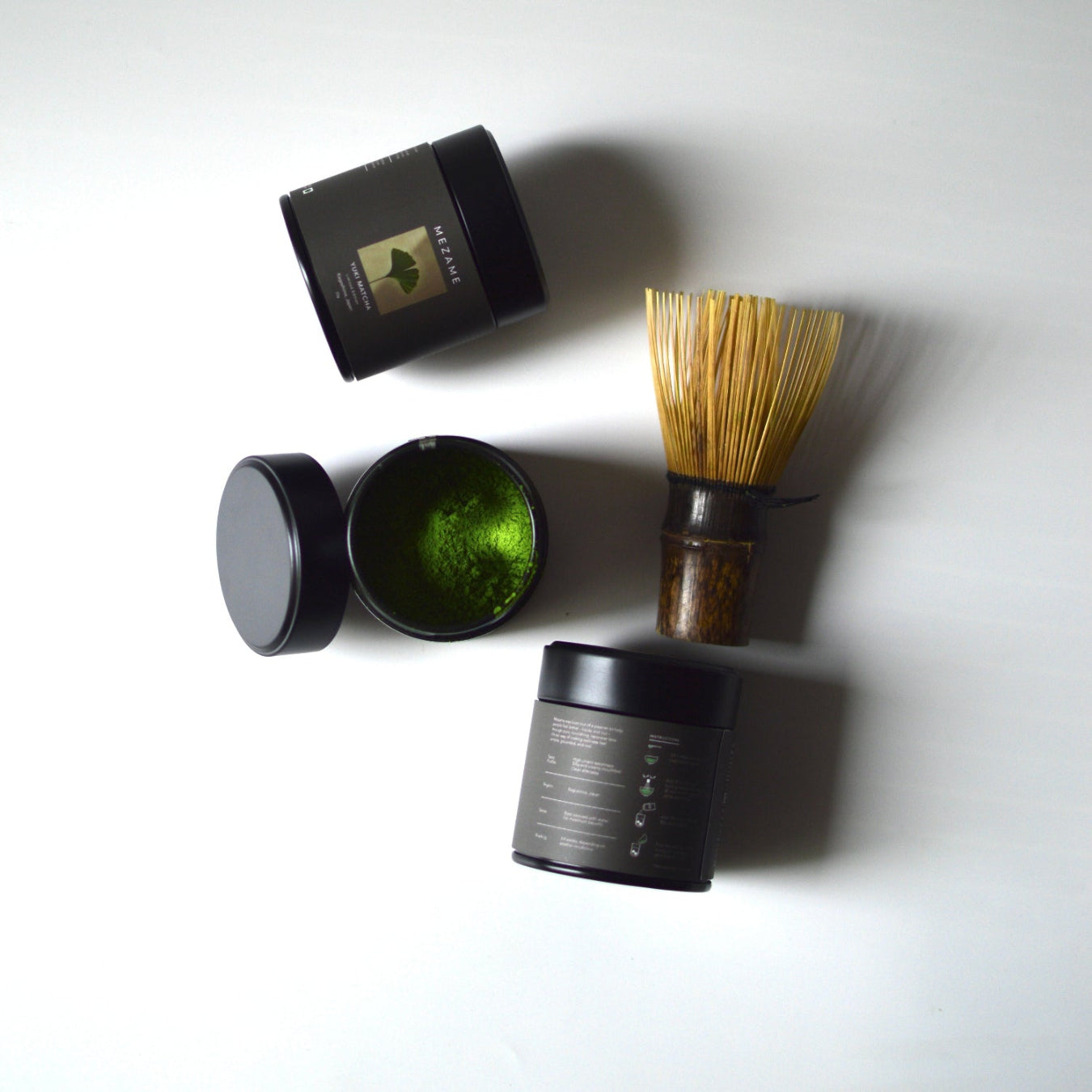 Mezame Yuki ceremonial Matcha preparation set  with green powder, whisk, and containers on a white background