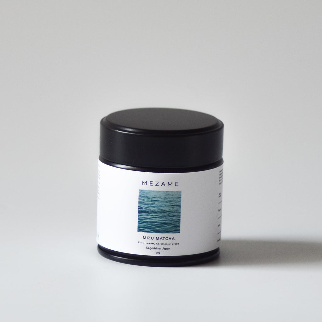 Small matcha tin with a black lid and white label on a light gray background