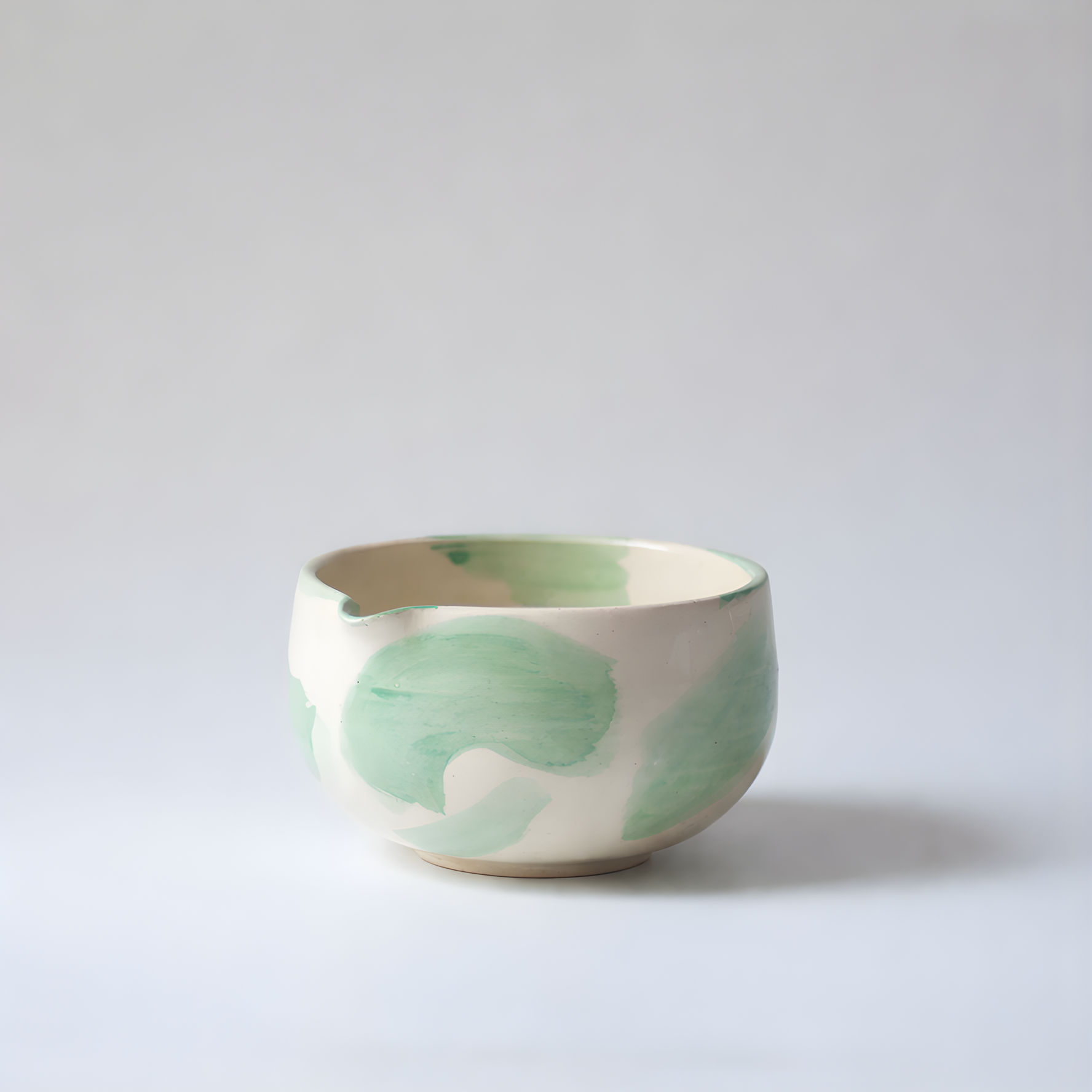 Ceramic Matcha Bowl / Chawan with green leaf patterns on a light gray background