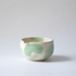 Ceramic Matcha Bowl / Chawan with green leaf patterns on a light gray background